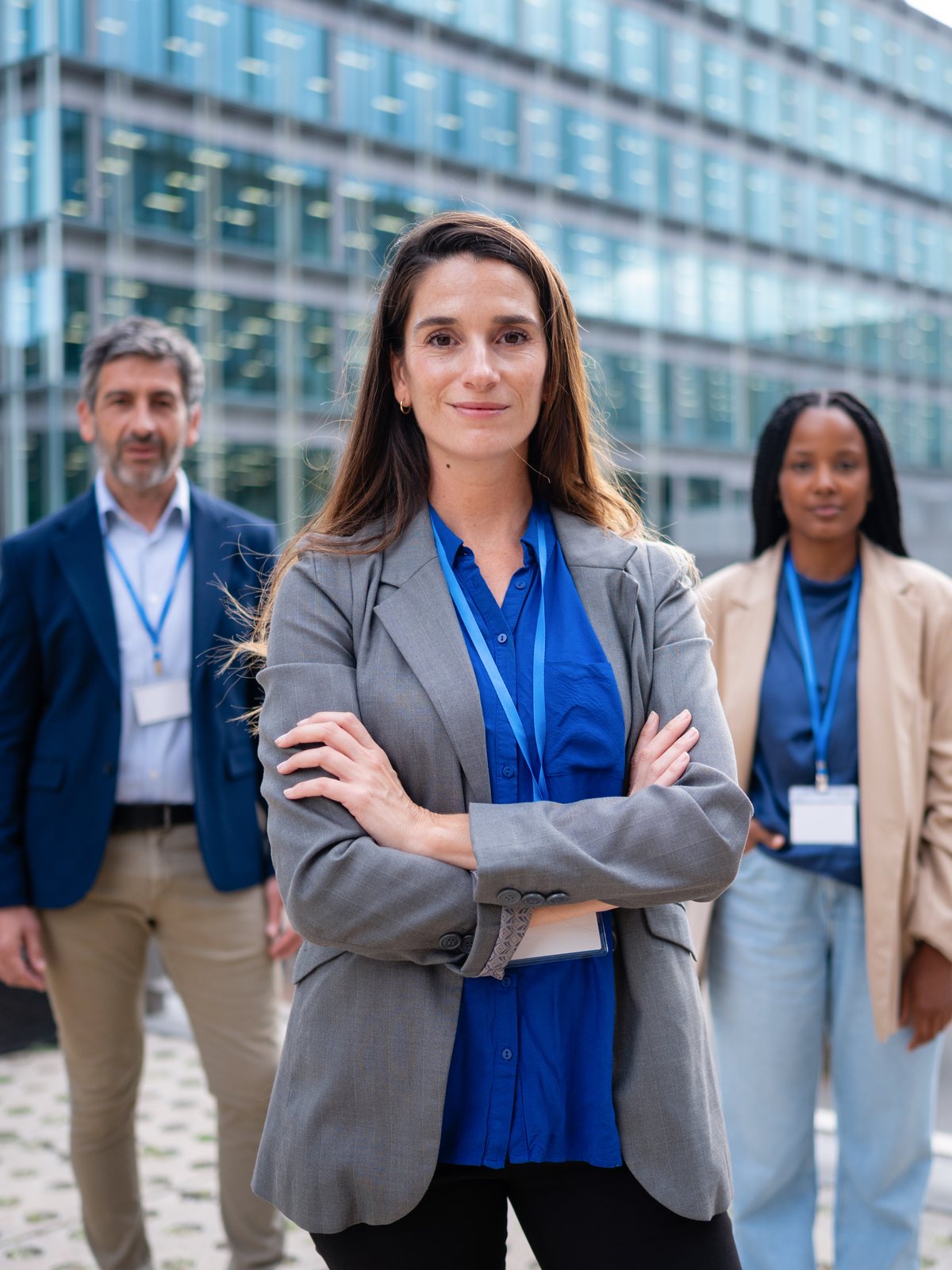 Confident government employee standing with colleagues outside a public building